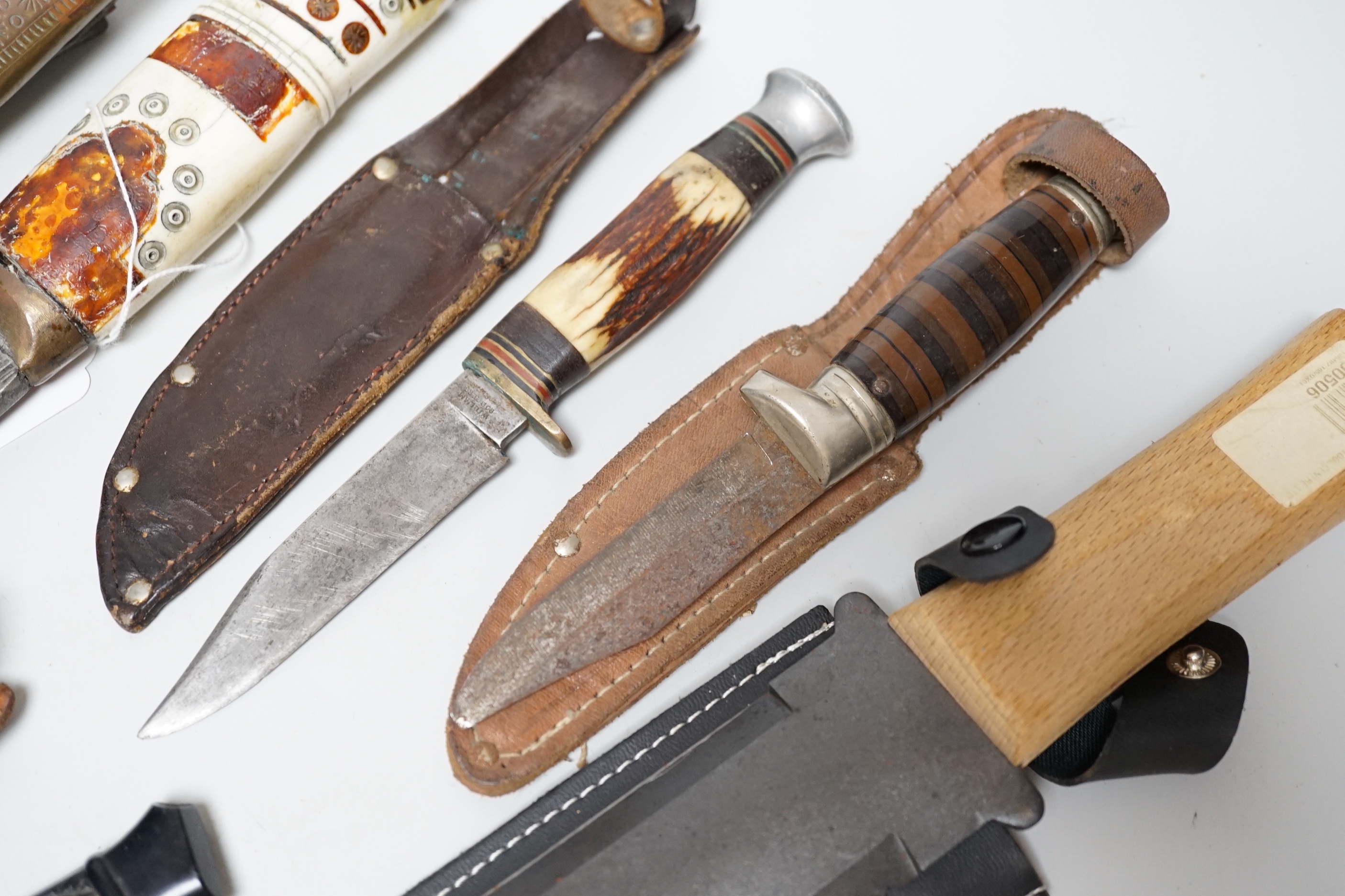 Eight knives including hunting knives, and bone handled Kukri example, the largest 42cm in length